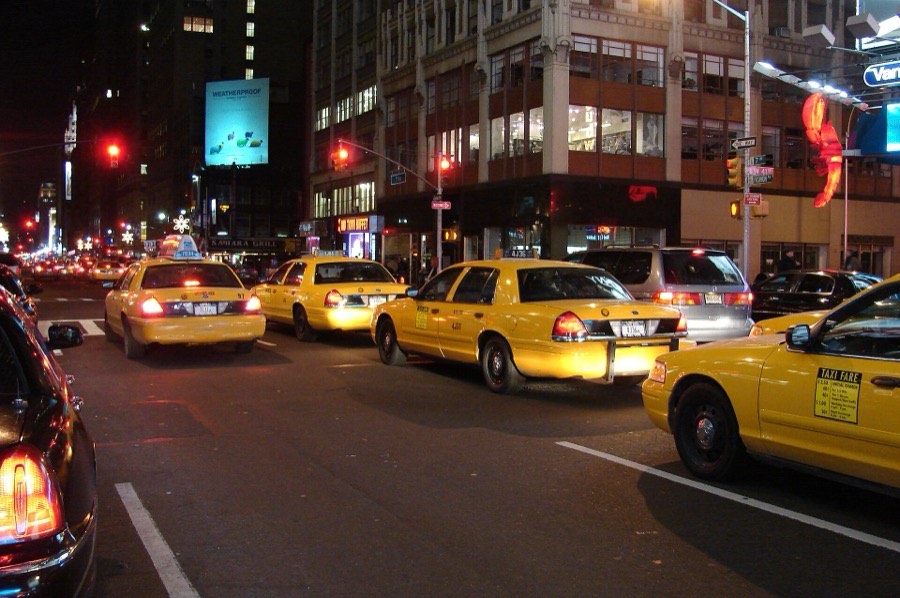 Yellow taxis on a New York City street at night